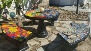 Mosaic Patio Table with bench seats by Naomi Haas.