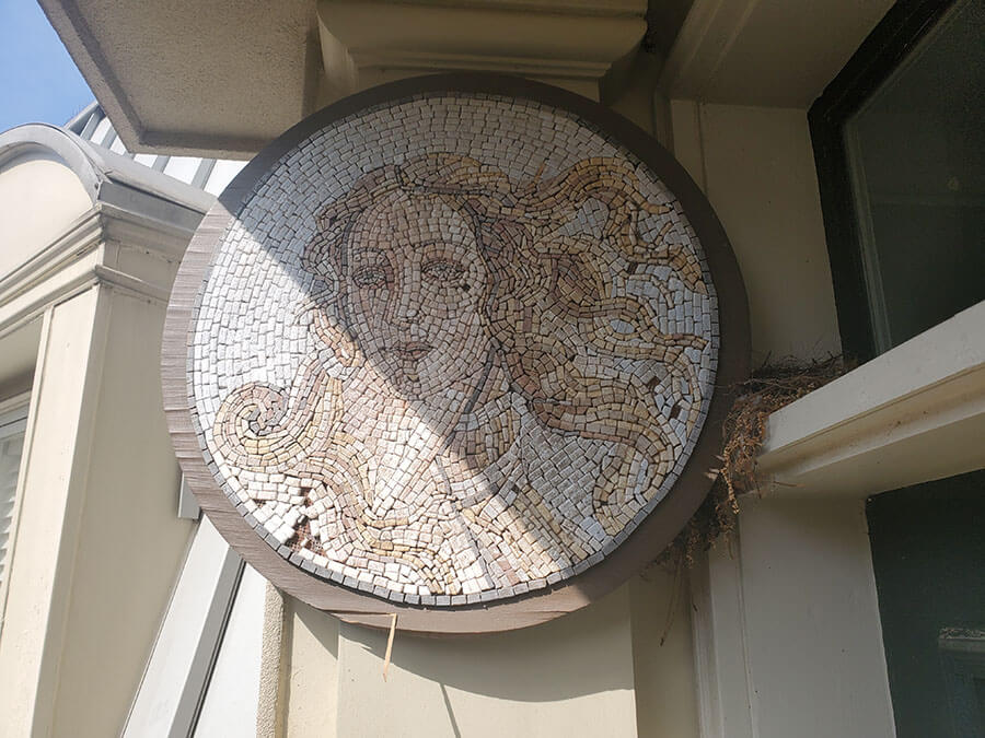 Mosaic interpretation of a detail from Botticelli's Venus deteriorating from the weather.