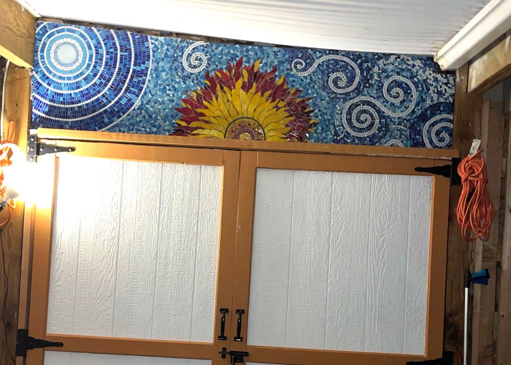 Celestial Mosaic installed on transom above outdoor workshop doors
