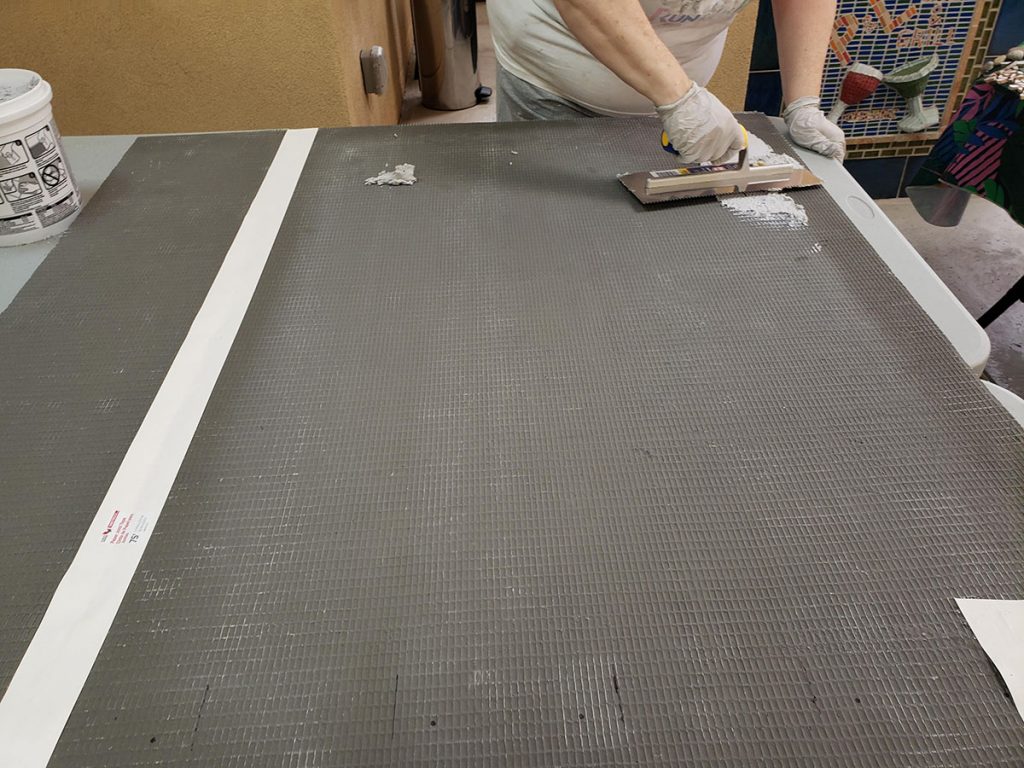 trowel-spreads-thinset-mortar-tile-backer-board