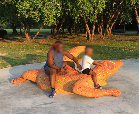 Mother and child on Lizard Mosaic Sculpture, City View Park